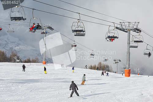 Image of Skiing slopes, with many people