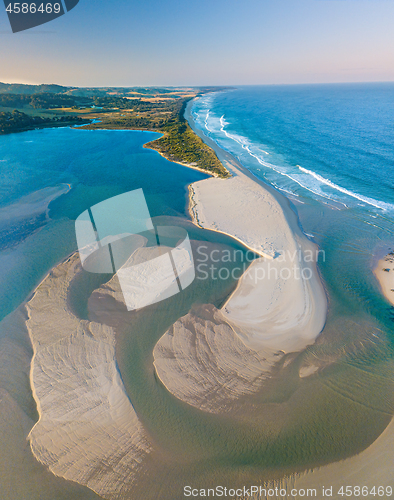 Image of Aerial view of sand patterns in the shallow waters of the ocean 