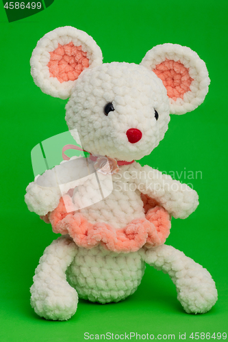 Image of Knitted toy mouse on a green background