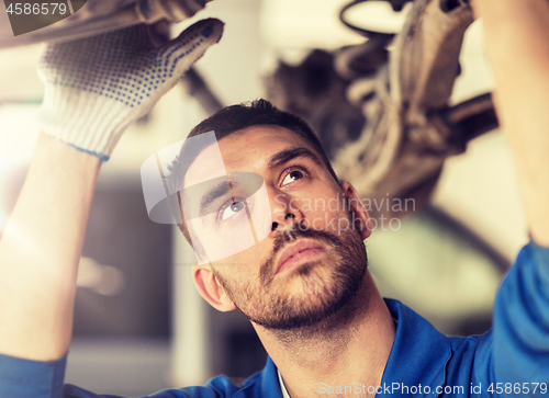 Image of mechanic man or smith repairing car at workshop