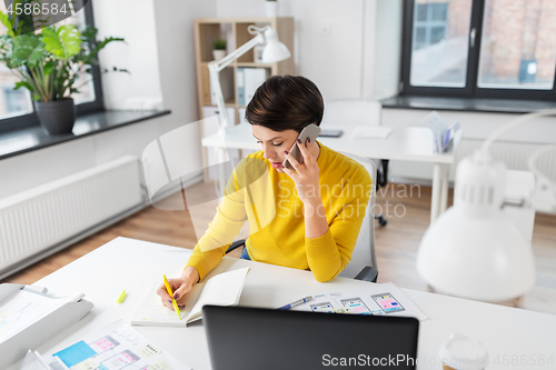 Image of ui designer calling on smartphone at office