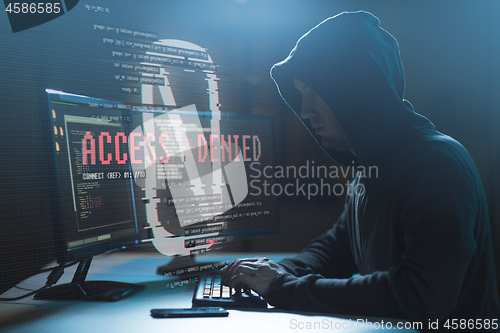 Image of hacker with access denied messages on computer