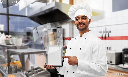 Image of happy indian chef with tablet pc over kebab shop