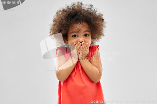 Image of confused african american girl covering mouth