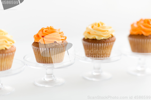 Image of cupcakes with frosting on confectionery stands