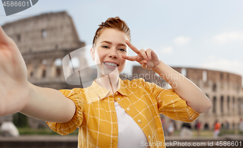 Image of redhead teenage girl taking selfie over coliseum