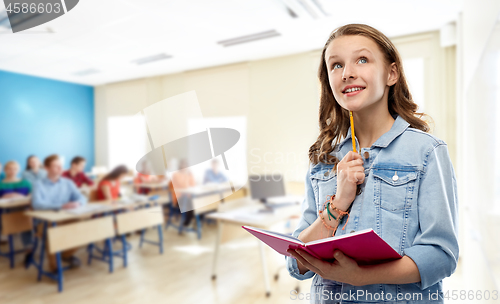 Image of teenage student girl with notebook at school