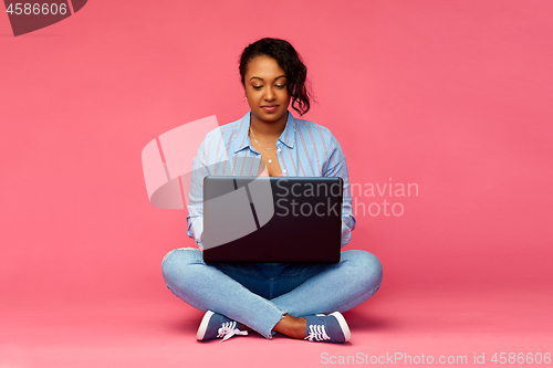 Image of happy african american woman with laptop computer