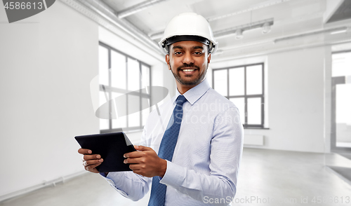 Image of architect or businessman in helmet with tablet pc