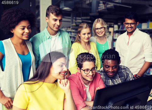 Image of international students with computers at library