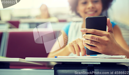 Image of close up of african student with smartphone