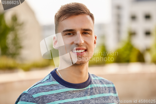 Image of portrait of young man in summer city