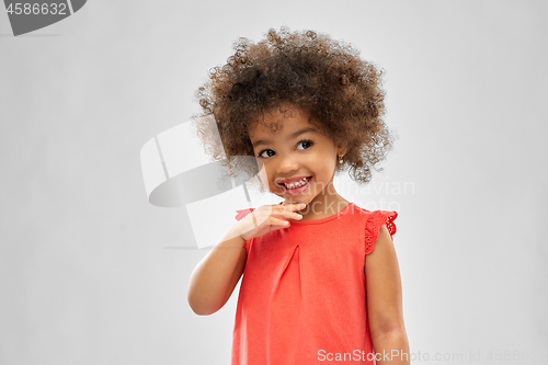 Image of happy little african american girl over grey