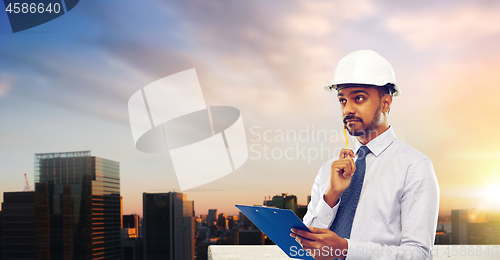 Image of architect or businessman in helmet with clipboard