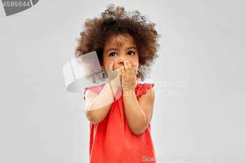 Image of confused african american girl covering mouth