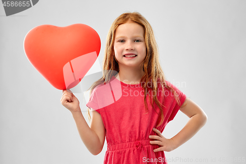 Image of smiling red haired girl with heart shaped balloon