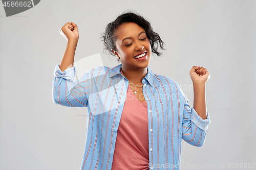 Image of happy african american woman celebrating success