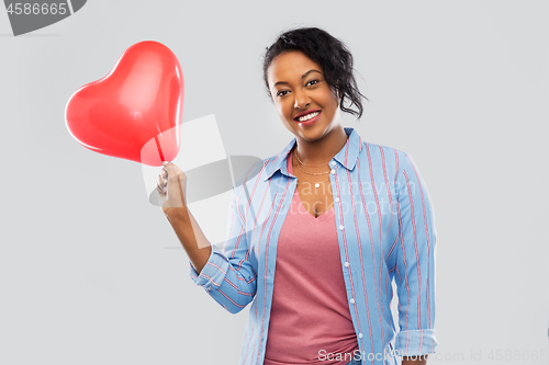 Image of african american woman with heart-shaped balloon