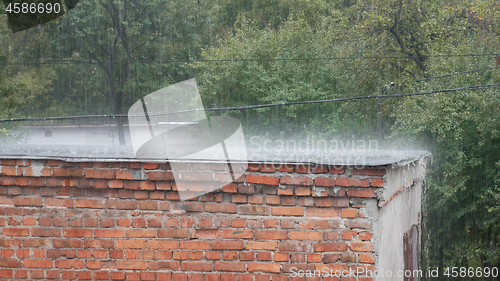 Image of Rain as downpour on roof of barn in summertime