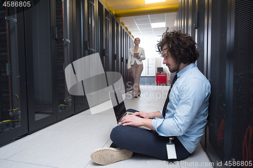 Image of Team of young technicians working together on servers