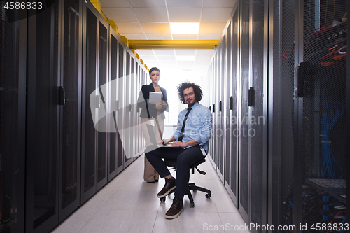 Image of Team of young technicians working together on servers