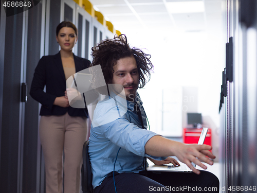 Image of Team of young technicians working together on servers