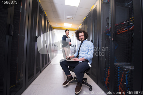 Image of Team of young technicians working together on servers