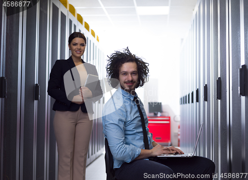 Image of Team of young technicians working together on servers