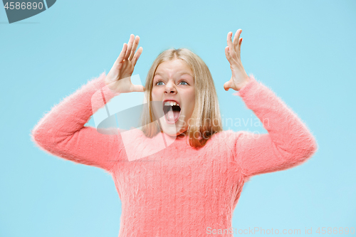 Image of Isolated on blue young casual teen girl shouting at studio