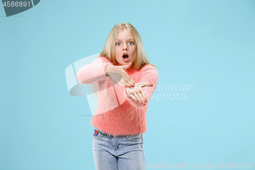 Image of Beautiful female half-length portrait on studio backgroud. The young emotional teen girl