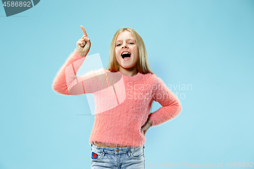 Image of Beautiful teen girl looking suprised isolated on blue