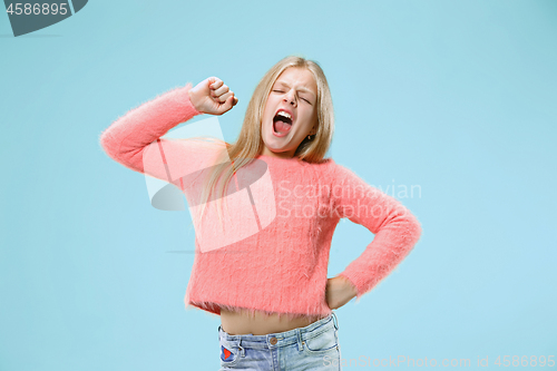 Image of Beautiful bored teen girl bored isolated on blue background