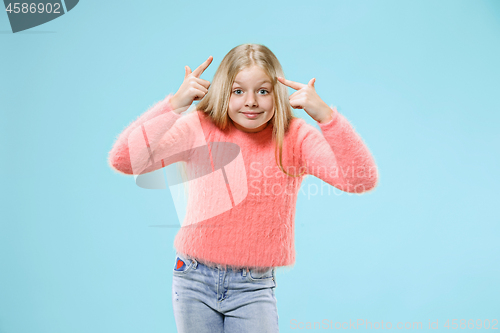 Image of Beautiful female half-length portrait on studio backgroud. The young emotional teen girl
