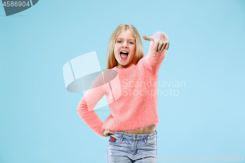 Image of Beautiful teen girl looking suprised isolated on blue