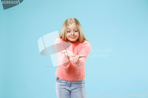 Image of Beautiful female half-length portrait on studio backgroud. The young emotional teen girl