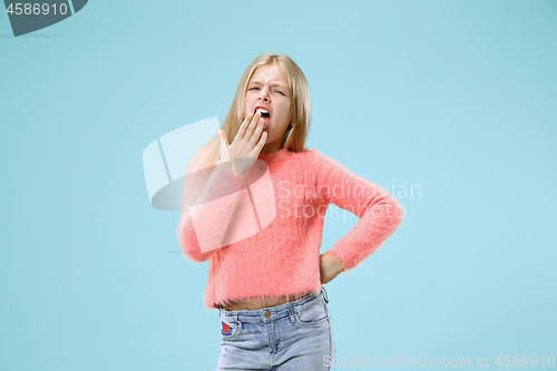 Image of Beautiful bored teen girl bored isolated on blue background