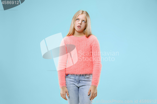 Image of Beautiful bored teen girl bored isolated on blue background