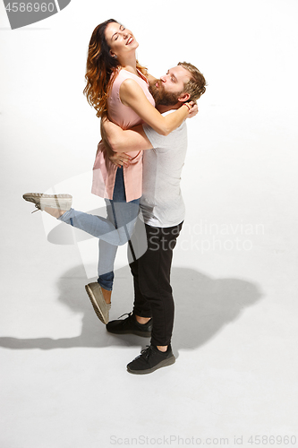 Image of Full body portrait of hugging couple with smile. Caucasian models in love