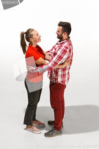 Image of Full body portrait of hugging couple with smile. Caucasian models in love