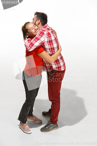 Image of Full body portrait of hugging couple with smile. Caucasian models in love