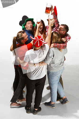 Image of Football fans hugging with beers on white background