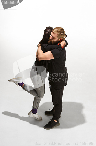 Image of Full body portrait of hugging couple with smile. Caucasian models in love