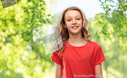 Image of smiling teenage girl over natural background