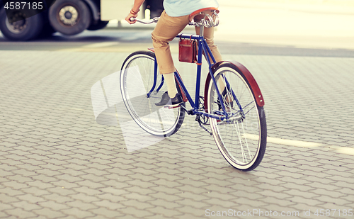 Image of hipster man riding fixed gear bike