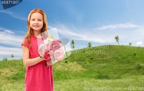 Image of happy red haired girl with flowers