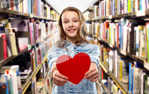 Image of smiling teenage girl with red heart over library