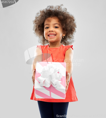 Image of happy little african american girl with gift box