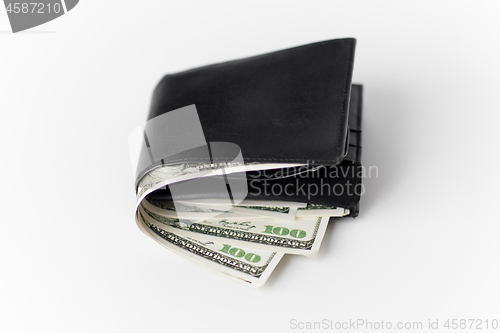 Image of close up of black wallet with dollar money