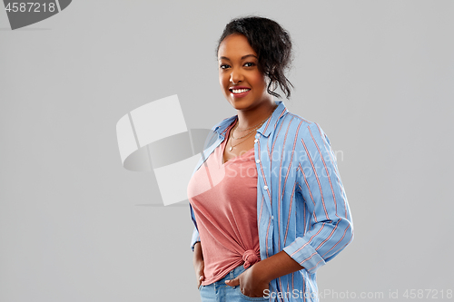 Image of happy african american woman over grey background