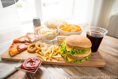 Image of close up of fast food and cola drink on table